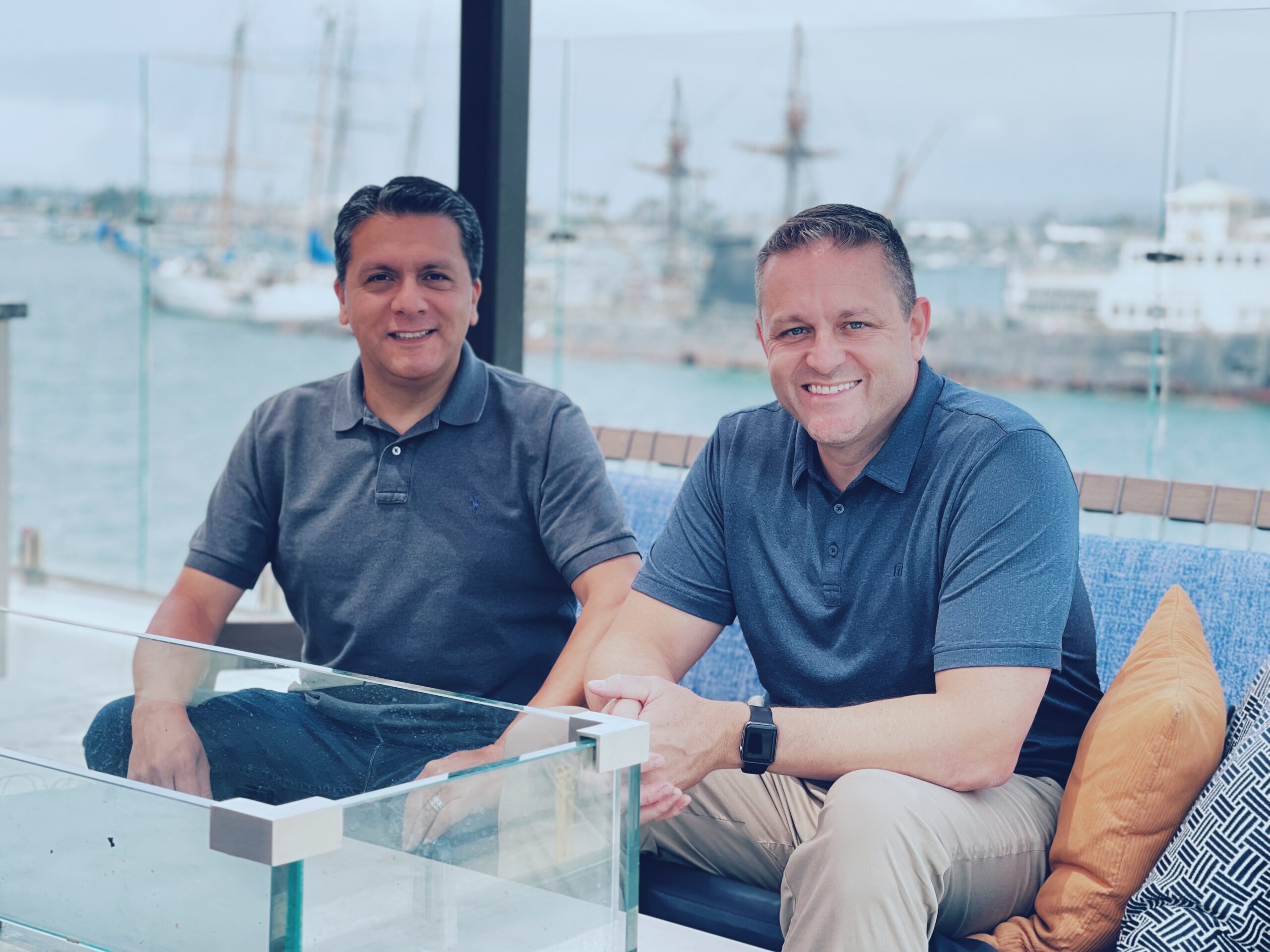Motus Coaching & Consulting team seated together in a bright waterfront setting